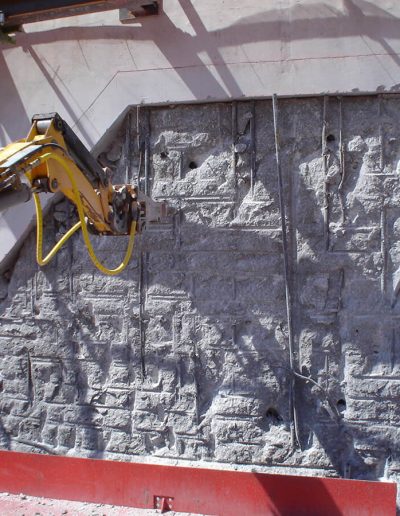 Robotic hammering work being done to a wall.