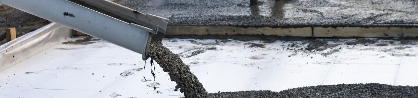 Concrete being poured at a construction site.